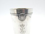 an image of a silver cup sitting on top of a white table