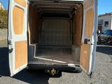 a white van with its door open in a parking lot