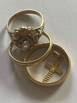 two gold rings that are sitting on top of each other