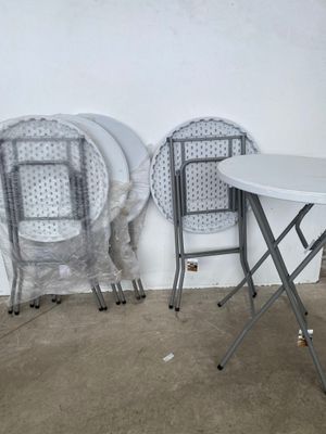 two chairs and a table in the corner of a room