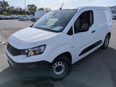 the white van is parked in a parking lot with other cars in the background