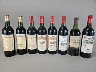 several bottles of wine are lined up on a table