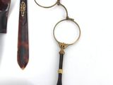 a pair of glasses, a pair of scissors, and a pair of eyeglasses on a white surface
