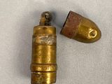 a close up of a bullet and a bullet on a white surface