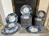 a lot of plates that are sitting on the floor