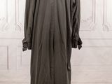 an image of a coat on a mannequin stand in a room