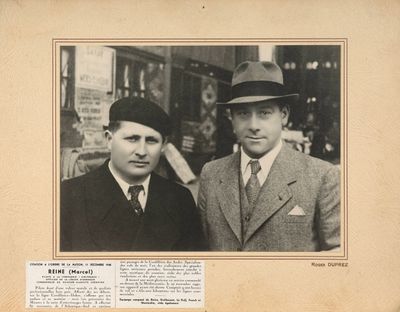 deux hommes en costume et chapeau, debout l'un à côté de l'autre