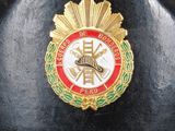 a black helmet with a red and gold emblem on it