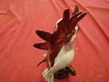 a figurine of a bird on a red cloth