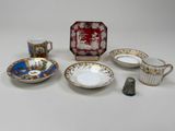 many different types of tea cups and saucers on the table