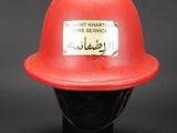 a red fire helmet with a sticker on it