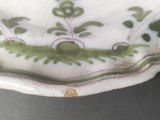 a close up of a plate with a flower design on it