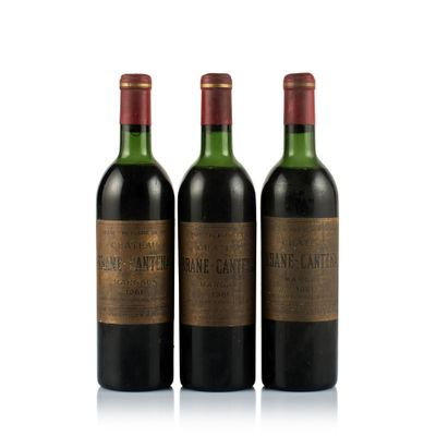 three bottles of wine sitting next to each other on a white surface