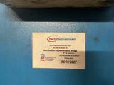 a label on the back of a machine that is sitting on a table