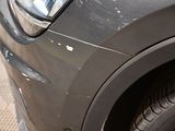 a close up of a car ' s front bumper and fender