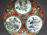 a red plate with four different designs on it