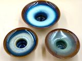 three blue and white bowls sitting on top of a white table