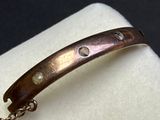a close up of a bracelet with a chain on it
