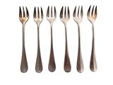 six forks are lined up in a row on a white surface
