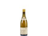 a bottle of white wine sitting on top of a white table