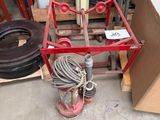 a red fire hydrant sitting on the floor next to a pile of other items
