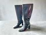 pair of black and silver boots on a white surface