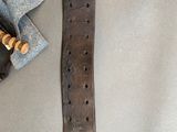 a leather belt and a pair of scissors on a table