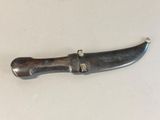 a knife that is laying on a table