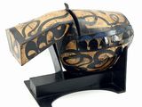 a wooden object with a black and gold design on it