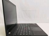 the back of a laptop computer sitting on top of a white table