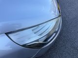 a close up of a car ' s headlight and front bumper