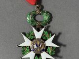 a close up of a medal on a table with a red ribbon