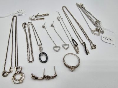 many different types of necklaces and bracelets on the table