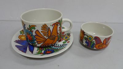 a cup and saucer sitting next to each other on a table