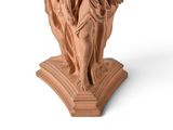 statue of an angel holding a cross on a pedestal