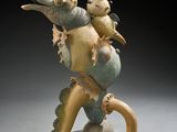an image of a sculpture of a seahorse with a fish on its back