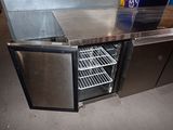 a stainless steel counter top with an open door