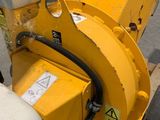 a yellow machine that is sitting on the side of the road