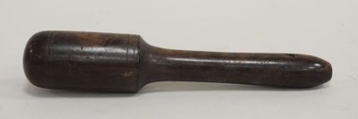 an old wooden hammer with a wooden handle on a white surface