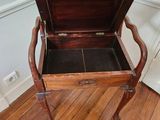 a wooden bench with a drawer on top of it