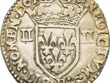 a silver coin with a crown on top of it