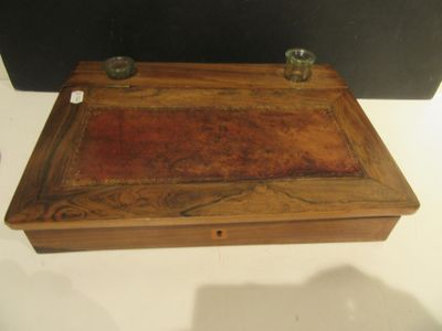 a small wooden box with two candles on it