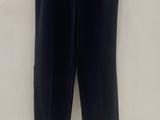 a black pants hanging on a hanger on a wall