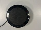 a black speaker that is connected to a white wall