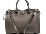 a gray handbag with a strap on a white background