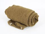 a roll of brown wool on a white surface