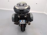 a motorcycle parked in a room with a license plate on the back of it