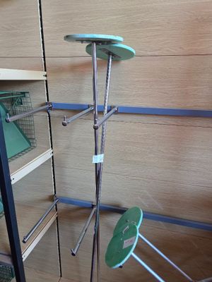 a shelf with several shelves and a green chair in the corner