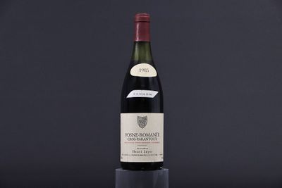 a bottle of wine sitting on top of a wooden table