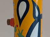 a yellow vase with a blue and white design on it